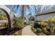 Landscaped walkway leading to a charming house entrance at 4907 Parson Brown Ln, Palm Harbor, FL 34684