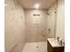 Modern bathroom with marble-tiled shower and floating vanity at 5809 N 17Th St, Tampa, FL 33610