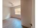 Bright bedroom with wood-look floors and backyard view at 5809 N 17Th St, Tampa, FL 33610