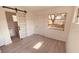 Bright bedroom with wood-look floors and a view of the backyard at 5809 N 17Th St, Tampa, FL 33610