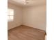 Simple bedroom with wood-look floors and ceiling fan at 5809 N 17Th St, Tampa, FL 33610