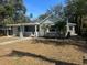 Charming renovated home with gray exterior and landscaped lawn at 5809 N 17Th St, Tampa, FL 33610