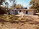 Rear view of a single story house with a large backyard at 5809 N 17Th St, Tampa, FL 33610
