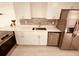Modern kitchen with white cabinets, stainless steel appliances, and quartz countertops at 5809 N 17Th St, Tampa, FL 33610