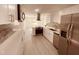 Modern kitchen with white cabinets, stainless steel appliances, and quartz countertops at 5809 N 17Th St, Tampa, FL 33610