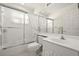 Clean bathroom featuring a shower/tub with sliding glass doors and a bright white vanity at 6594 Fairway Gardens Dr # 6594, Bradenton, FL 34203