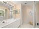 Bathroom with a double sink vanity and a spacious glass shower, offering a spa-like experience at 6594 Fairway Gardens Dr # 6594, Bradenton, FL 34203