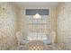 Cozy breakfast nook with white wicker chairs, glass table, and natural light, perfect for morning meals at 6594 Fairway Gardens Dr # 6594, Bradenton, FL 34203