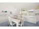 Bright kitchen and dining area featuring white cabinets, modern appliances, and ample counter space at 6594 Fairway Gardens Dr # 6594, Bradenton, FL 34203