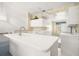 Modern kitchen with white cabinetry, tile floors, and ample counter space at 6594 Fairway Gardens Dr # 6594, Bradenton, FL 34203