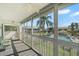 Enclosed lanai with a view of the pool, community lawn, and lush palm trees at 6594 Fairway Gardens Dr # 6594, Bradenton, FL 34203