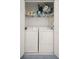 Convenient laundry room featuring a washer and dryer, as well as storage shelves for supplies at 6594 Fairway Gardens Dr # 6594, Bradenton, FL 34203