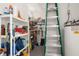 Functional storage area with shelving and ladder for accessing upper spaces at 6594 Fairway Gardens Dr # 6594, Bradenton, FL 34203