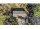 Birds eye view of small house, showing roof and car parked in the natural driveway area at 13107 Texel Ave, New Port Richey, FL 34654