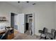 Neutral bedroom with beige carpet with an open closet and a desk space for home office at 16605 Myrtle Sand Dr, Wimauma, FL 33598