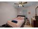 Charming bedroom featuring a ceiling fan, pink accents, and ample natural light from the window at 16605 Myrtle Sand Dr, Wimauma, FL 33598