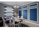 Formal dining room features modern white table, stylish decor, designer lighting, and black and white accents at 16605 Myrtle Sand Dr, Wimauma, FL 33598