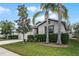 Charming single-story home featuring a well-manicured lawn, palm trees, and an attached two-car garage at 16605 Myrtle Sand Dr, Wimauma, FL 33598