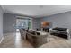 Comfortable living room with sliding doors to the pool area, tile flooring, and neutral color palette at 16605 Myrtle Sand Dr, Wimauma, FL 33598