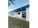 Exterior view of the back patio with black trimmed windows and sliding glass doors at 302 E Clay Ave, Brandon, FL 33510