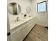 Bathroom features double vanity with modern fixtures and a sleek, round mirrors at 302 E Clay Ave, Brandon, FL 33510