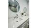 Bright bathroom featuring double sinks, quartz countertops and modern round mirrors at 302 E Clay Ave, Brandon, FL 33510