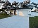 Renovated single-story home featuring a two-car garage and modern architectural details at 302 E Clay Ave, Brandon, FL 33510