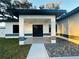 Contemporary front entrance with tiled front porch and stylish, dark-framed double entry doors at 302 E Clay Ave, Brandon, FL 33510