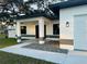 Inviting front porch with stone details and modern lighting that enhance the home's curb appeal at 302 E Clay Ave, Brandon, FL 33510