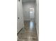 Hallway features modern gray wood-look flooring, white walls, and black door hardware at 302 E Clay Ave, Brandon, FL 33510