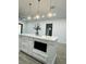 Bright kitchen island with a built in microwave and stylish pendant lighting at 302 E Clay Ave, Brandon, FL 33510