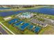 Stunning aerial view of community amenities including pool, tennis courts, pickleball, and sand volleyball at 5916 Jensen View Ave, Apollo Beach, FL 33572