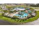 Aerial view of the community pool and clubhouse, surrounded by palm trees and amenities at 5916 Jensen View Ave, Apollo Beach, FL 33572