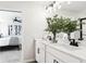 Well-lit bathroom featuring a double sink vanity, elegant hardware, and a view into the bedroom at 5916 Jensen View Ave, Apollo Beach, FL 33572