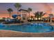 Inviting community pool area with a slide and splash pad, set against a beautiful sunset backdrop at 5916 Jensen View Ave, Apollo Beach, FL 33572