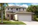 Charming two-story home with neutral siding, brown shingles, and attached two-car garage at 5916 Jensen View Ave, Apollo Beach, FL 33572