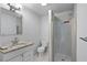 Updated bathroom with granite countertop and a shower at 8514 N Mitchell Ave, Tampa, FL 33604