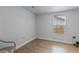 Spacious bedroom with wood-look floors and a window offering natural light at 8514 N Mitchell Ave, Tampa, FL 33604