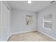 Bright bedroom with wood-look tile floors and double closets at 8514 N Mitchell Ave, Tampa, FL 33604