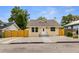 Updated bungalow with new paint, fenced yard, and a paved walkway at 8514 N Mitchell Ave, Tampa, FL 33604