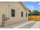 House exterior showcasing light beige walls and gravel driveway at 8514 N Mitchell Ave, Tampa, FL 33604