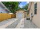Detached garage with a gravel driveway and wooden fence at 8514 N Mitchell Ave, Tampa, FL 33604