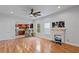 Spacious living area with hardwood floors, kitchen views, and a fireplace at 8514 N Mitchell Ave, Tampa, FL 33604