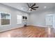 Living room with hardwood floors, fireplace, and ceiling fan at 8514 N Mitchell Ave, Tampa, FL 33604