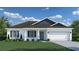 One-story home with gray roof, white walls, and blue accents at 17516 Waco Ave, Port Charlotte, FL 33948