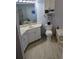 Bathroom with corner vanity, toilet and view of soaking tub at 721 Plumbrook Rd, Sun City Center, FL 33573