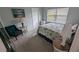 Cozy bedroom with a queen-size bed and comfortable seating at 721 Plumbrook Rd, Sun City Center, FL 33573