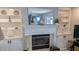 Fireplace with built-in shelving, decorative accents, and a large mirror at 721 Plumbrook Rd, Sun City Center, FL 33573