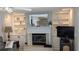 Living room fireplace with built-in shelving and a large mirror above at 721 Plumbrook Rd, Sun City Center, FL 33573