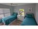 Well-lit guest bedroom featuring two twin beds and a dresser at 721 Plumbrook Rd, Sun City Center, FL 33573